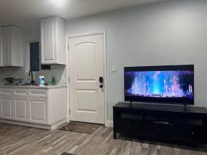 a kitchen with a flat screen tv in a living room at Guest house near UCD Med. Center in Sacramento