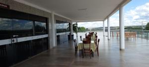 a dining room with chairs and tables in a building at Gurgueia Palace Hotel in Bom Jesus
