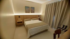 a small bedroom with a bed and a window at Gurgueia Palace Hotel in Bom Jesus