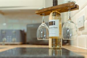 two bottles of wine on a counter in a kitchen at Branlea - In the Heart of Ludlow in Ludlow