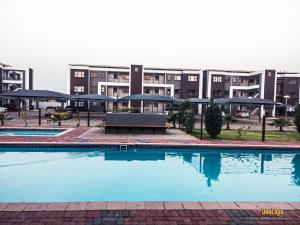 an empty swimming pool in front of a building at DeeLops Apt 304 @Sarona City in Gaborone