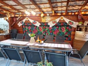a dining room with tables and chairs and a blanket at Casa Spilt in Borşa