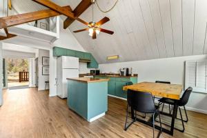 a kitchen with blue cabinets and a wooden table at Peaceful North Fork Cabin w/ Fireplace & Wi-Fi! in North Fork