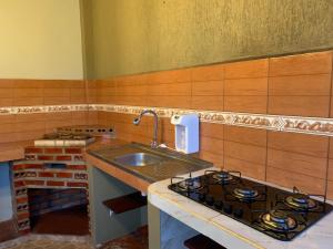 a kitchen with a stove and a sink at Alojamiento céntrico in Cobija