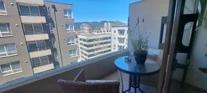 a balcony with a table and a view of a building at Claro Centro Temuco in Temuco