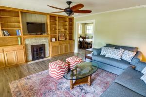 a living room with a blue couch and a fireplace at Centrally Located Abilene Abode 2 Mi to Downtown! in Abilene