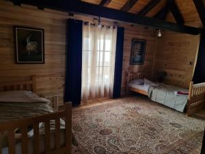 a bedroom with two beds and a window at Eco Lodge Taor in Taor