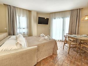 a hotel room with a bed and a table at Apartamentos Las Ciencias Studio Y in Valencia