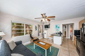 a living room with a couch and a ceiling fan at Tropical Blue Water beachside 7 in Clearwater Beach