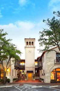 a building with a tower with a clock on it at Mr. Nomad: Artistic Abode in Uptown in Dallas