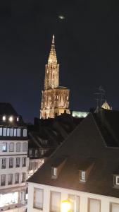 a tall building with a clock tower at night at 2p lumineux au Cœur de Strasbourg in Strasbourg