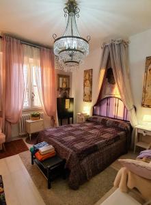 Un dormitorio con una cama grande y una lámpara de araña. en Suite in House.., en Florencia