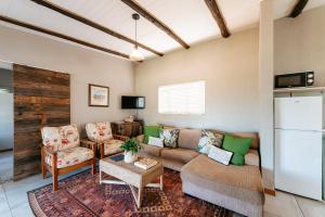 a living room with a couch and a tv at Dennehof Farm Guesthouse in Villiersdorp