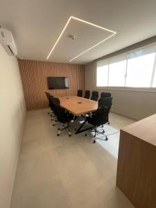 une salle de conférence avec une table et des chaises en bois dans l'établissement Hotel Solar Paulista, à São Paulo