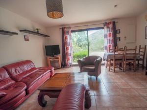 a living room with a couch and a table at gîte mas d'en pachette in Le Boulou