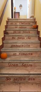 a stairway with writing on the steps at Casa Fra Ambrogio in Pizzoli