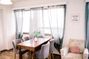 a dining room with a table and chairs and a window at La Playa Suites 2 in Periyiálion
