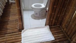a small bathroom with a toilet and a white towel at Balneario el paraíso in Puerto Triunfo