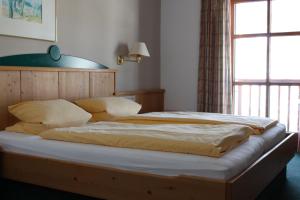 Apartments Embach في امباخ: سرير كبير في غرفة مع نافذة
