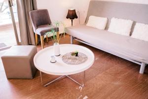 ein Wohnzimmer mit einem Sofa und einem Tisch in der Unterkunft La Playa Suites 1 in Periyiálion