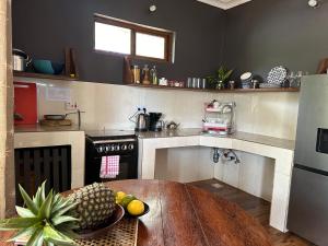a kitchen with a table with a bowl of fruit on it at Cozy private villa in Fukuchani in Mchangani