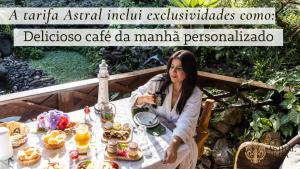 a woman sitting at a table with food at Pousada Astral da Ilha in Ilha do Mel