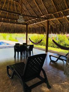 a patio with a hammock and a table and chairs at Parcela el paraiso in Doradal