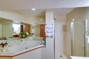 a bathroom with a large tub and a shower at Burnside Resort Cabin with Hot Tub and Outdoor Spots! in Burnside +27 photos