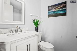 a white bathroom with a sink and a toilet at Family Friendly - Sleeps 6 - King Bed in Incline Village