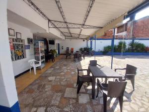 a patio with tables and chairs in a building at Hotel Guaipa in Melgar