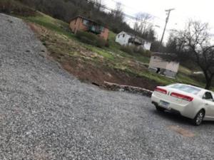 a white car parked on the side of a road at Red Roof Home Accommodates 10 people! in Tazewell