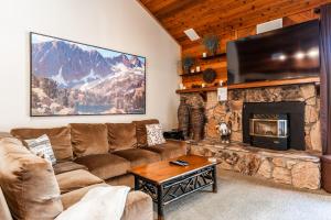 a living room with a couch and a fireplace at Snowflower #47 - Updated 2 Bedroom & Loft, 3 Bath, Sleeps 8, Steps away from Free Town Shuttle in Mammoth Lakes