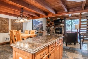a kitchen and dining room with a large island in a house at Snowflower #47 - Updated 2 Bedroom & Loft, 3 Bath, Sleeps 8, Steps away from Free Town Shuttle in Mammoth Lakes