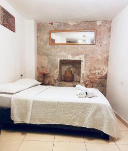 a bedroom with a bed and a fireplace at Casa Mamá Waldy Hostel in Cartagena de Indias
