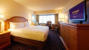 a hotel room with a bed and a flat screen tv at Eldorado Reno Hotel & Casino - A Caesars Rewards Destination in Reno