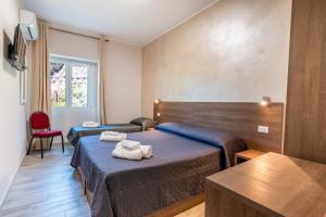 pokój hotelowy z 2 łóżkami i oknem w obiekcie Hotel Ristorante La Mimosa w mieście Lamezia Terme
