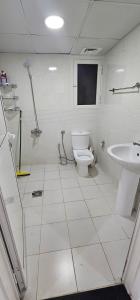 a bathroom with a toilet and a sink at SKY 9 Hostel ,UNION METRO in Dubai