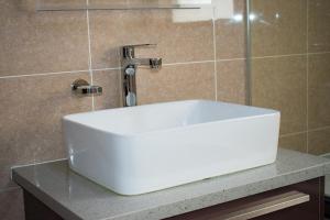 un lavandino bianco su un bancone in bagno di Candymoore apartment a Sandton