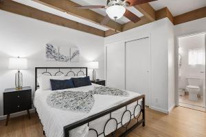 a bedroom with a bed and a ceiling fan at Mission Bay Condo - Steps to Sand, Dining, AC, Parking & Shops! in San Diego