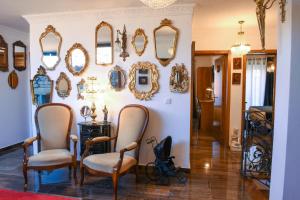 a room with chairs and mirrors on a wall at PH in Alto Douro Vinhateiro in Urros
