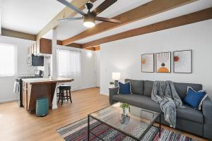 a living room with a couch and a table at Mission Bay Condo - Steps to Sand, Dining, AC, Parking & Shops! in San Diego