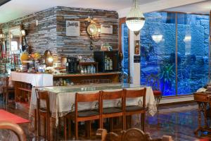 a restaurant with a table and a large window at PH in Alto Douro Vinhateiro in Urros