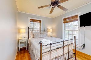 a bedroom with a bed and a ceiling fan at The Answer in Edisto Island