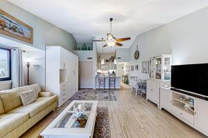 a living room with a couch and a table at Ocean’s Treasures Retreat Beach Condo in Ponte Vedra Beach