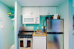 a small kitchen with a refrigerator and a microwave at Making Memories in Myrtle Beach