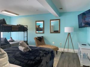 a bedroom with blue walls and a bunk bed at Wood Fire-pit! BBQ Grill! Cal King bed! Pets OK! Washer & Dryer! Wifi! in Charlotte