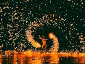 a person standing in the water in the rain at Lotus Paradise Resort - SHA PLUS in Ko Tao