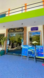 a store front with two signs in front of it at Lotus Paradise Resort - SHA PLUS in Koh Tao