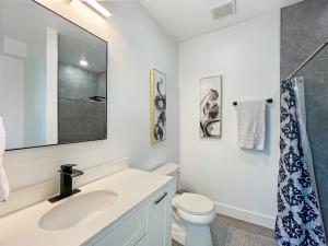 a white bathroom with a sink and a toilet at Mary's Stay H St Corridor in Washington, D.C. +154 photos
