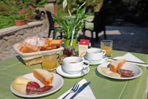 a table with plates of bread and cups of coffee at Villa Elisa in Agerola